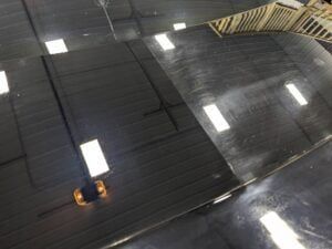 An aerial view of a warehouse with a lot of lights on the ceiling.