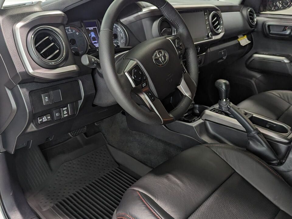 The interior of a toyota tacoma with black leather seats and a steering wheel