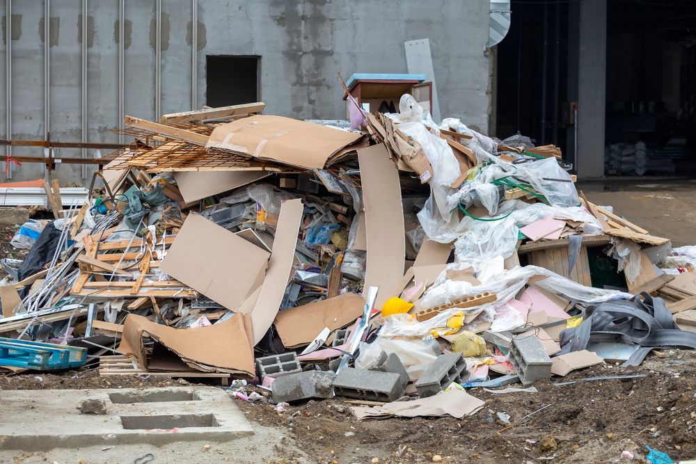 a pile of trash is sitting on the ground in front of a building .