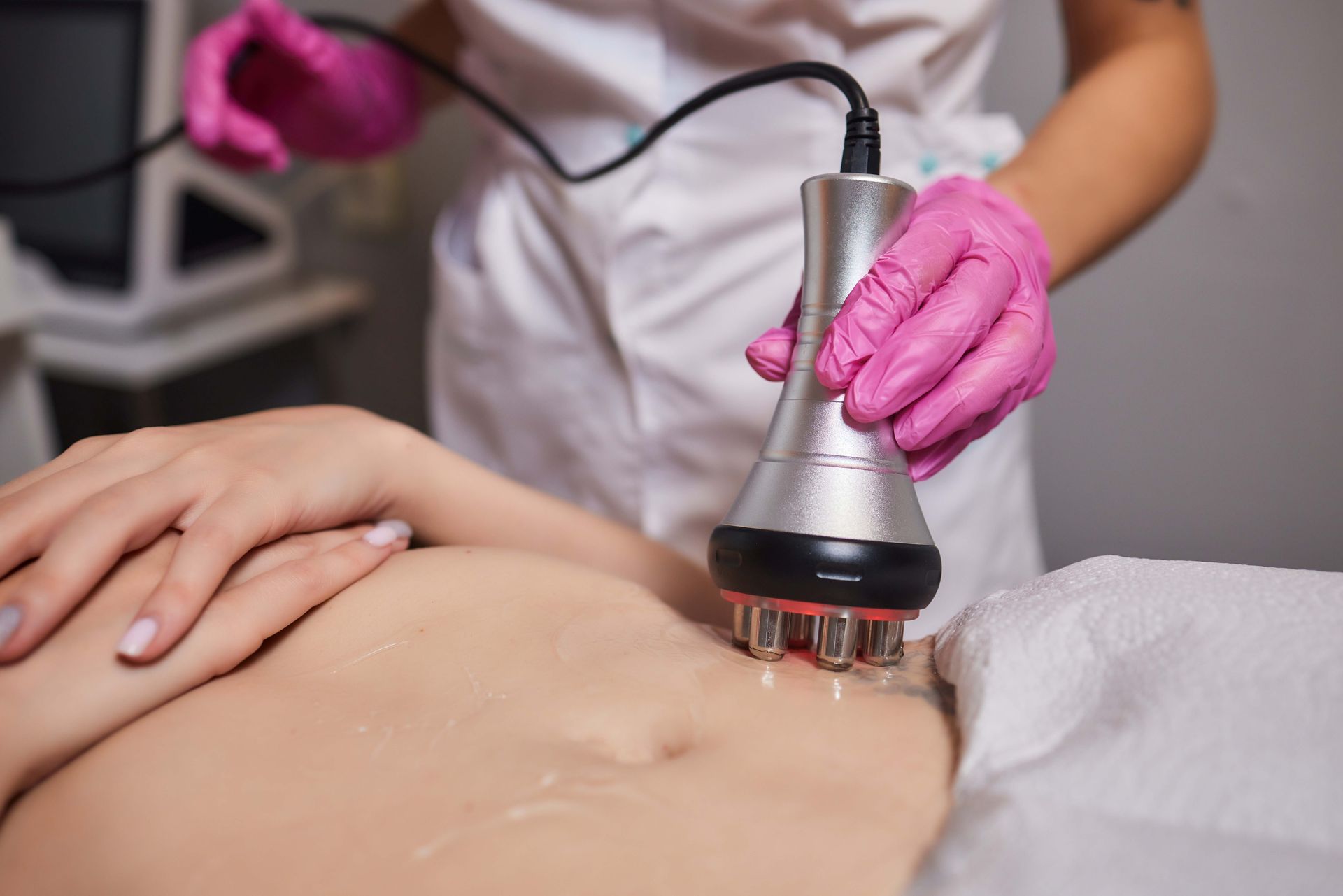 A woman is getting body sculpting treatment. A woman is getting body sculpting treatment.