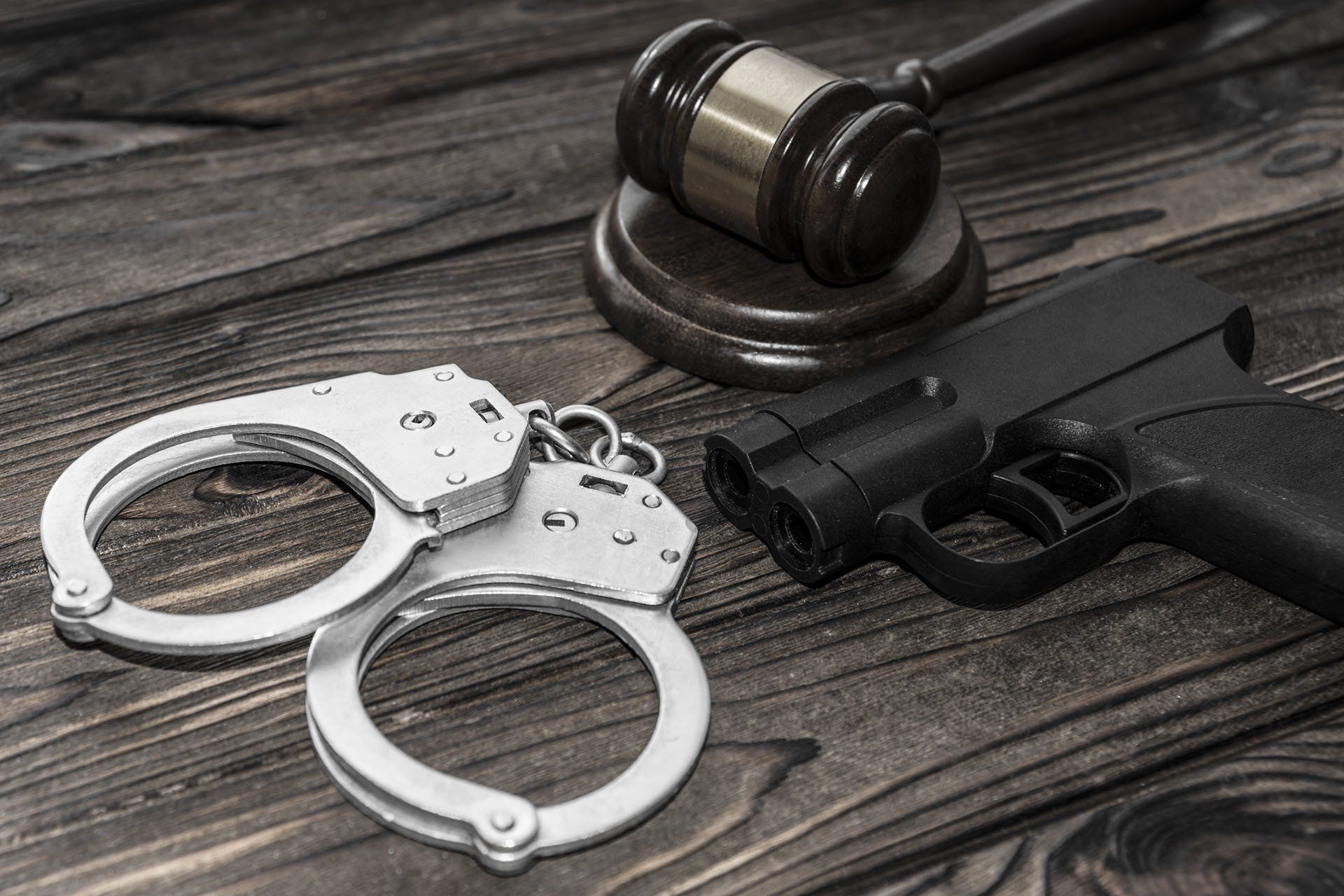 Gun and Handcuffs — Watkinsville, GA — Law Offices of Eric K. Krasle