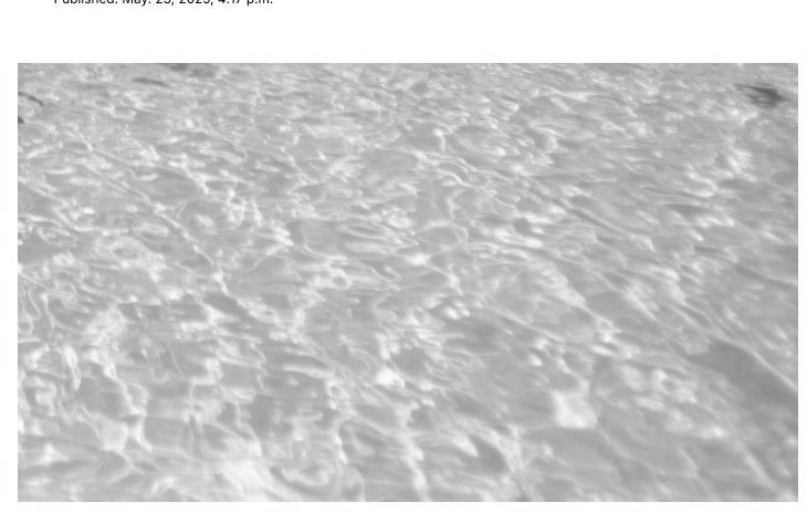 Water's surface, shimmering with light and ripples.