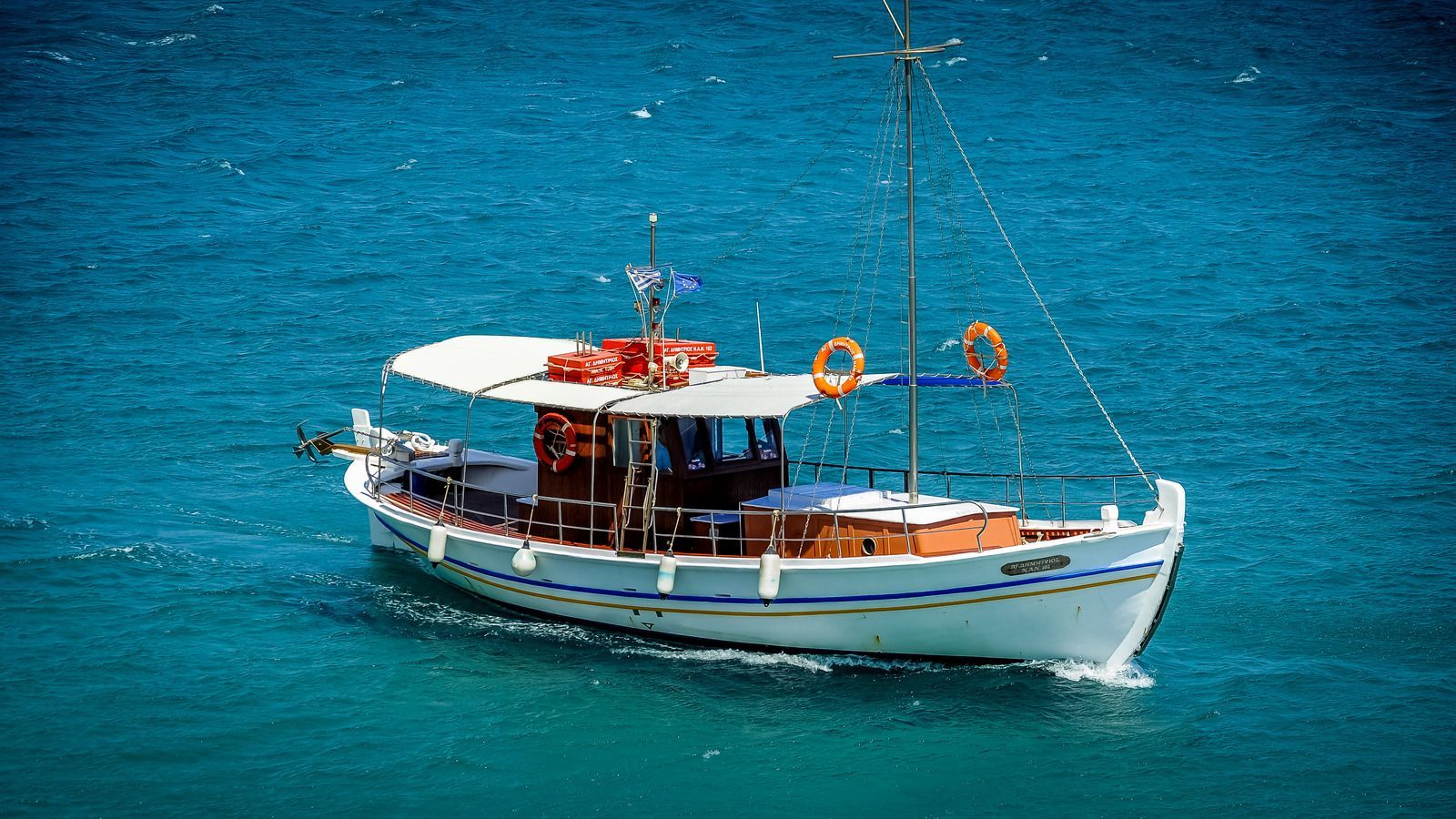 A small boat is floating on top of a large body of water.