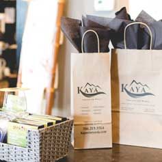 Two paper bags filled with tissue paper are sitting on a table.
