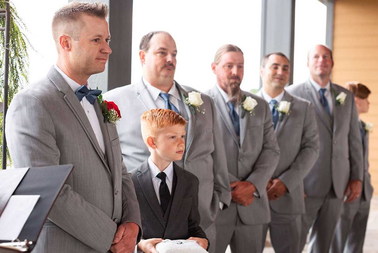 A group of men in suits and ties are standing in a line.