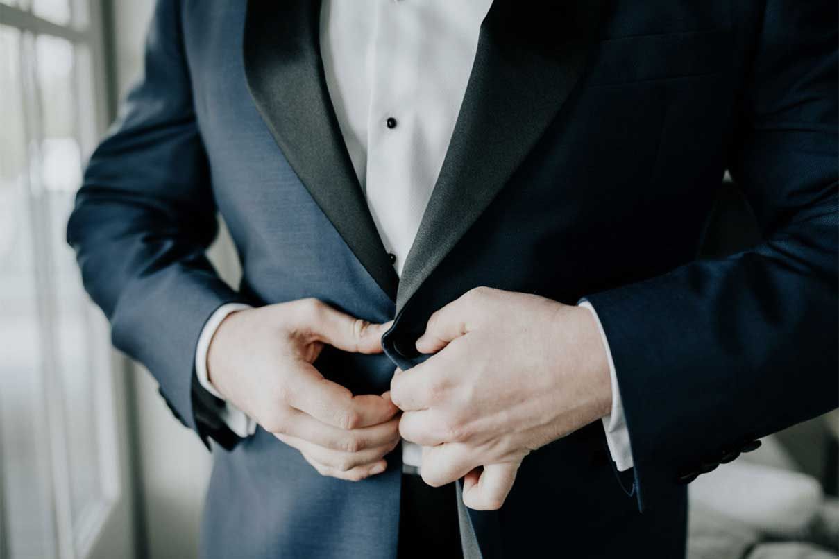 A man in a tuxedo is getting ready for his wedding.