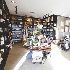 There is a table in the middle of the room in a store.