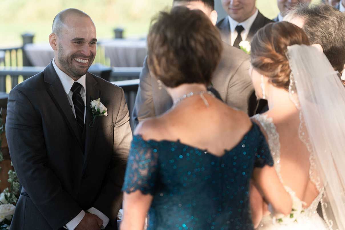 A bride and groom are standing next to each other at a wedding ceremony.