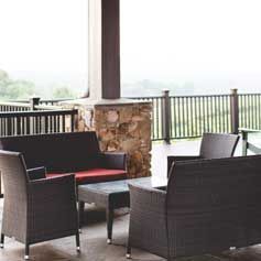 A patio with a couch , chairs , and a table.