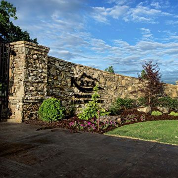 A stone wall with a sign that says kara on it