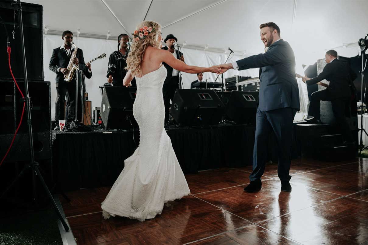 A bride and groom are dancing on a dance floor at their wedding reception.