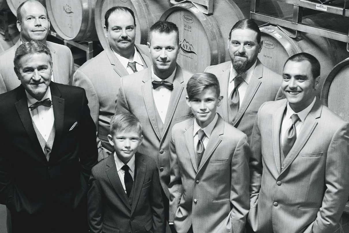 A group of men in suits and ties are posing for a picture.