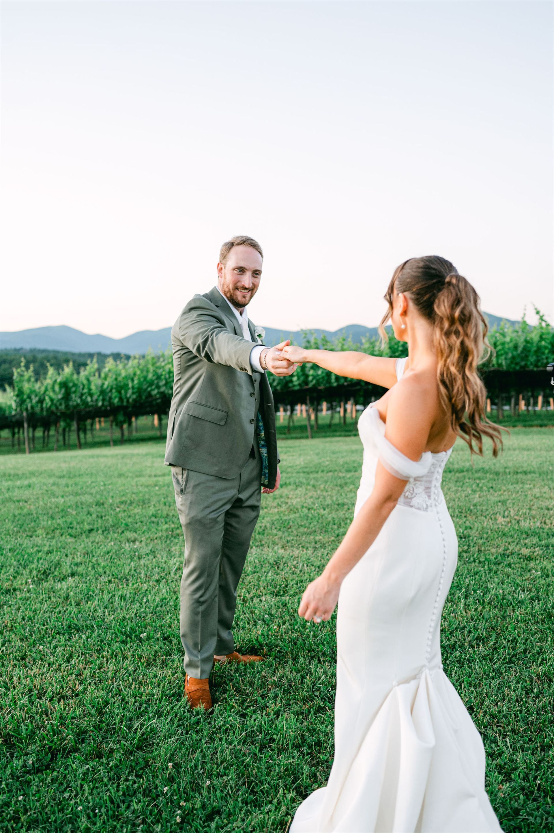 A bride and her father are walking down the stairs of a house.