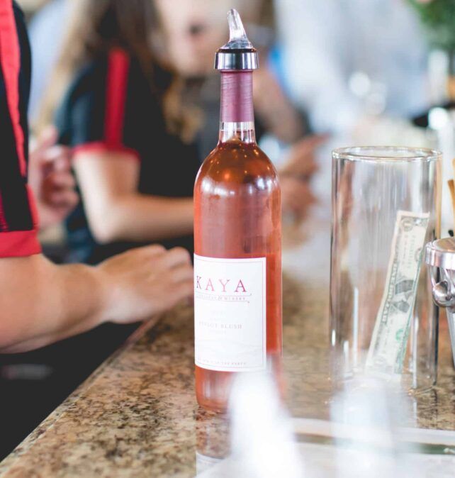 A bottle of kaya wine sits on a counter