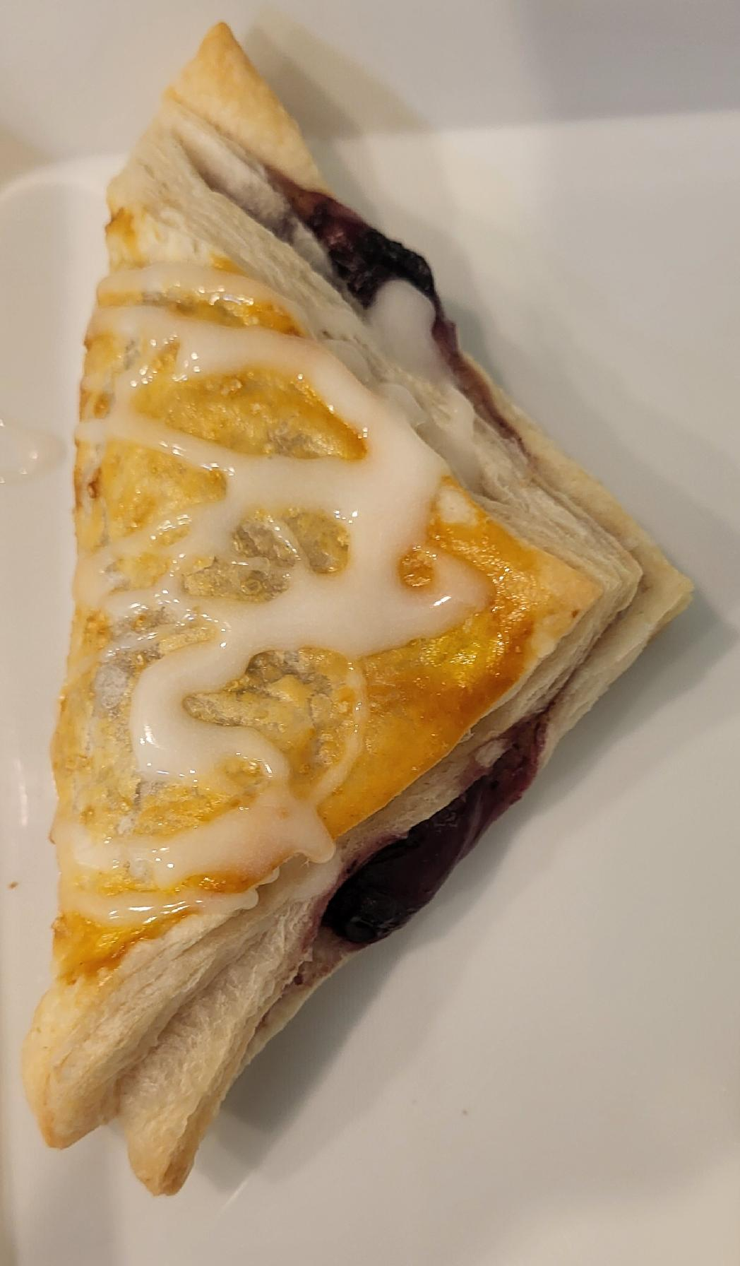 A table laden with treats: mini pineapple upside-down cakes, chocolate chip cookies, brownies, and a veggie tray.