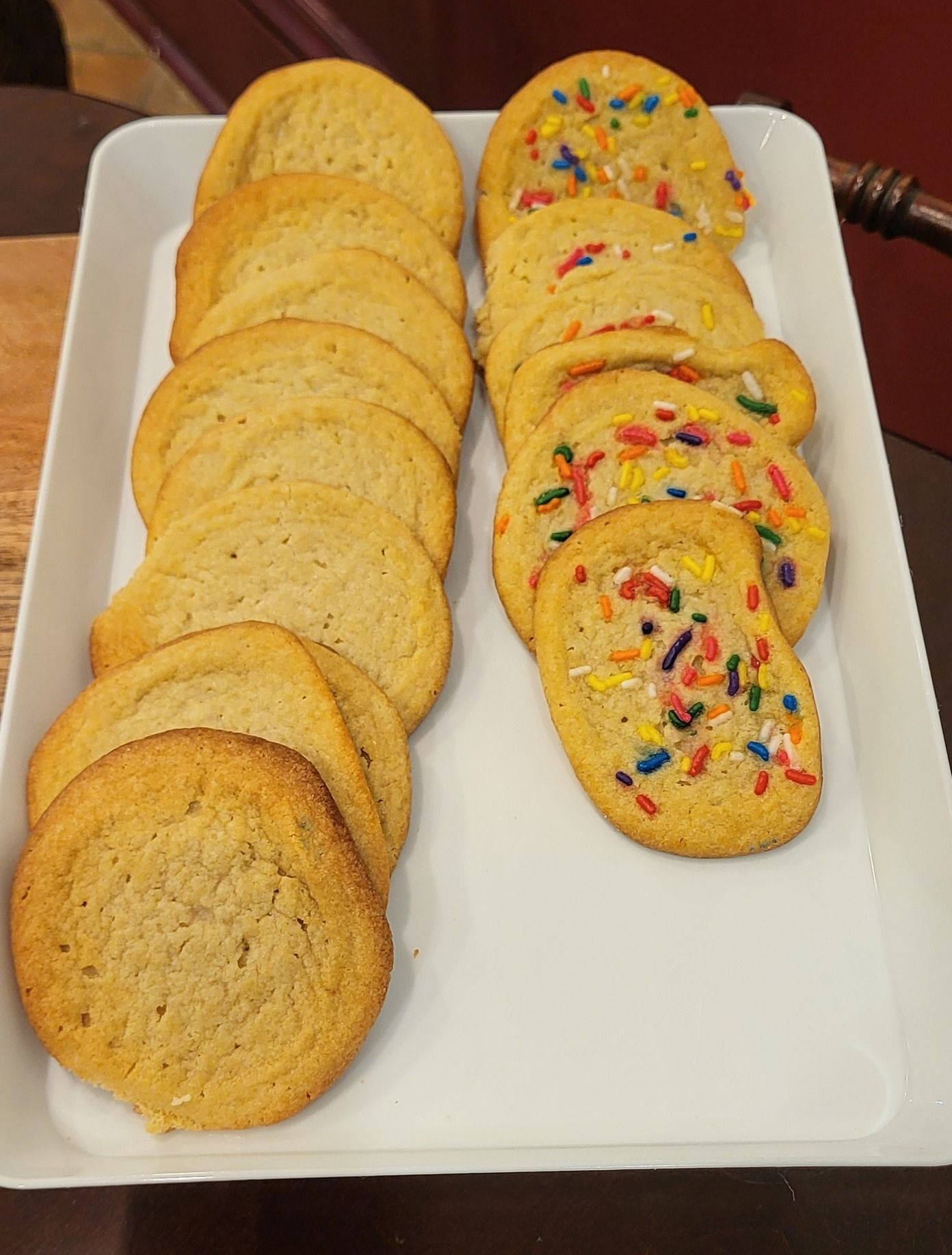 Bakery display with rows of golden croissants and tarts.