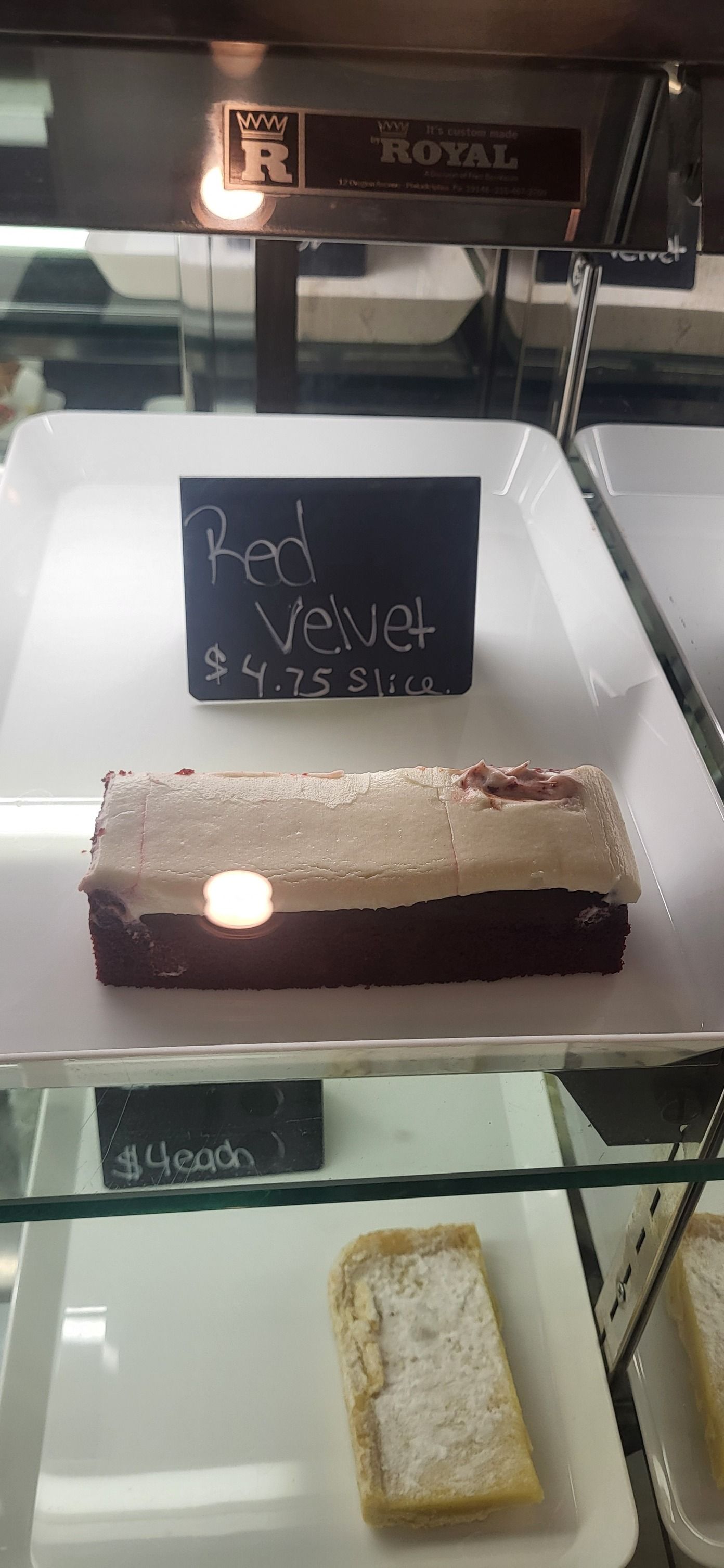 Two chocolate brownies topped with chocolate chips and pumpkin seeds on a white plate.