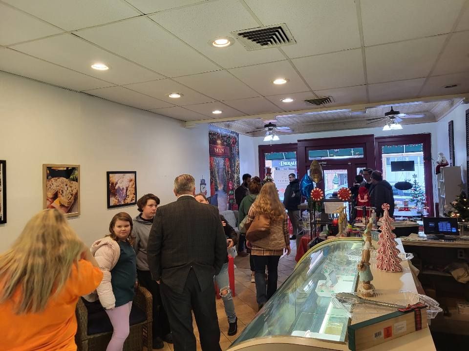 Chocolate cupcakes with swirled frosting and pink heart sprinkles in red cupcake liners.