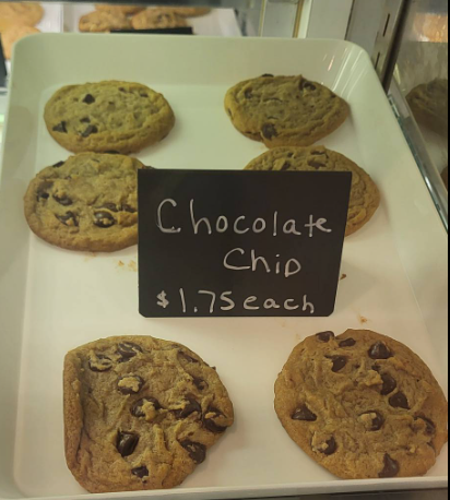 Baked fruit pie with a decorative crust, resting in a white parchment paper nest.