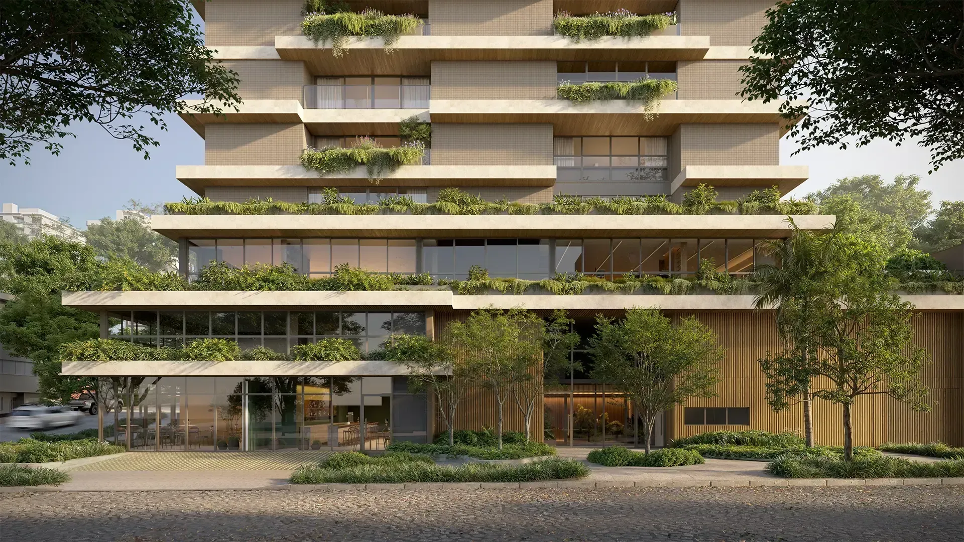 Prédio moderno com seções retangulares sobrepostas e vegetação nas varandas.