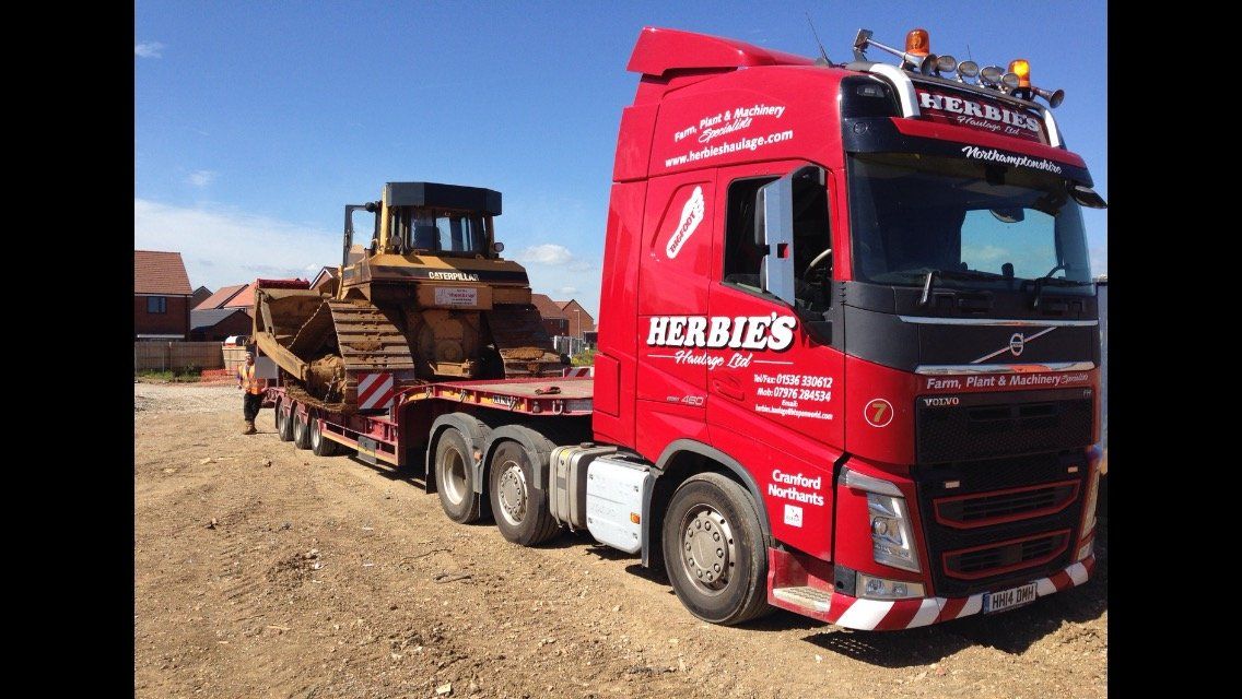 haulage vehicle on road carrying plant machinery