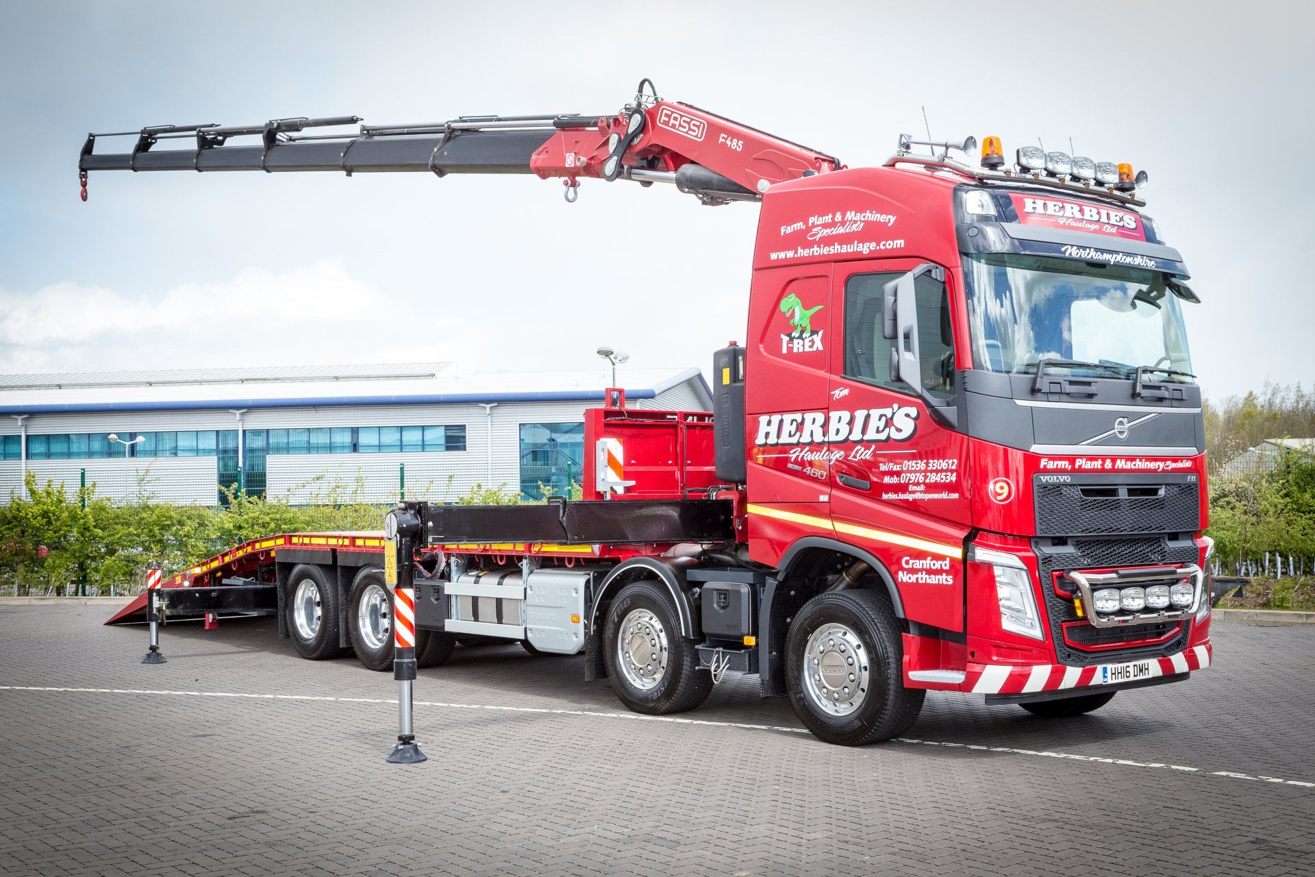 Haulage vehicle carrying heavy machinery on road