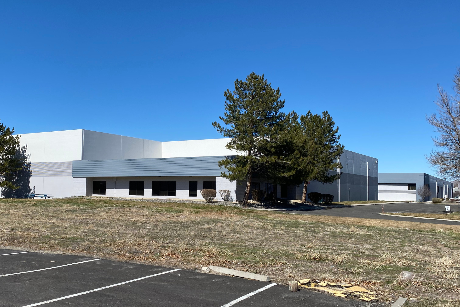 A large building with a parking lot in front of it