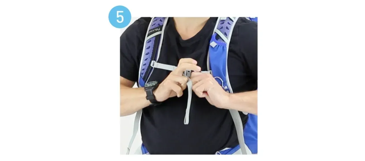 A man is wearing a black shirt and a blue backpack.