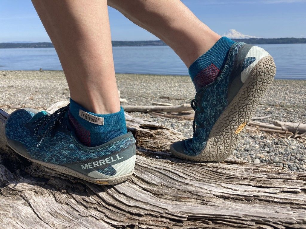A close up of a person 's feet walking on a path.