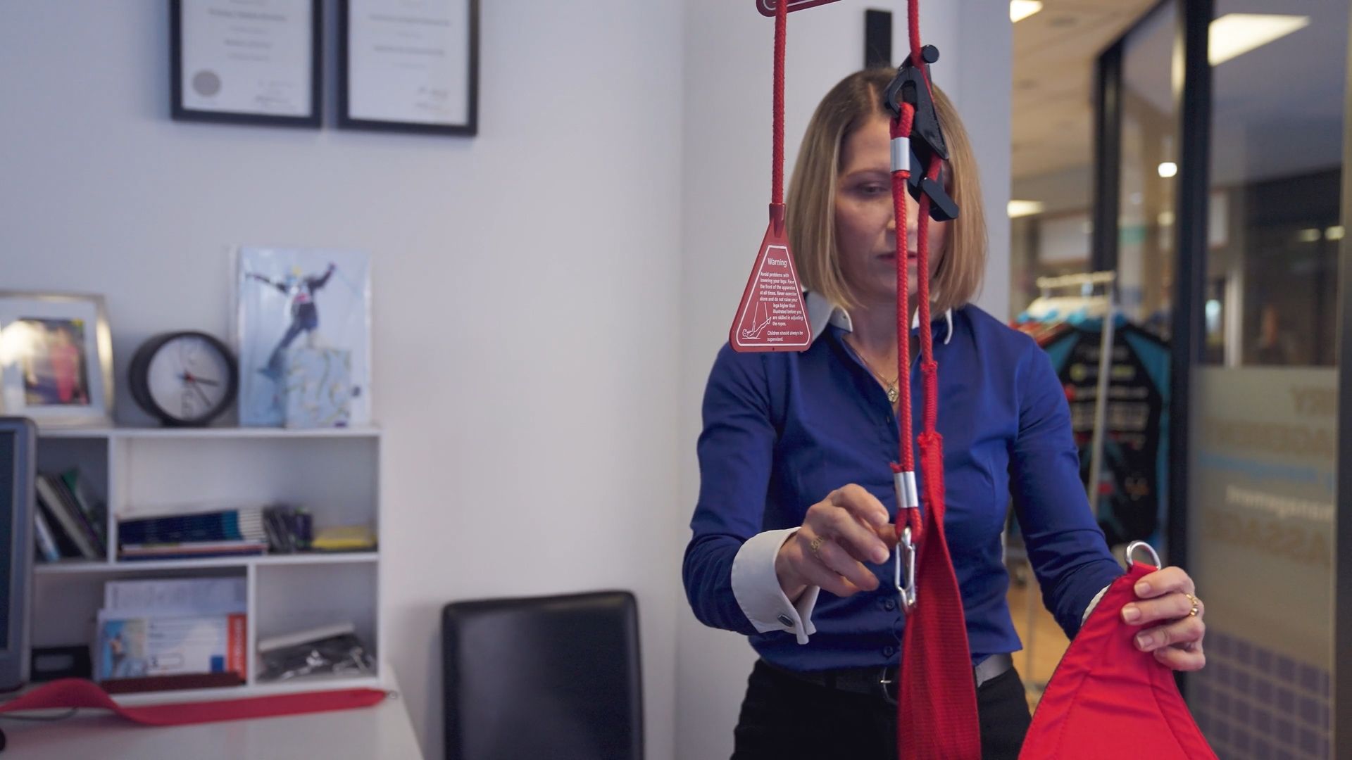 A woman in a blue shirt is setting up for a treatment