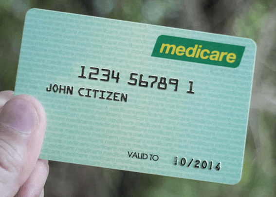 A person is holding a medicare card for john citizen