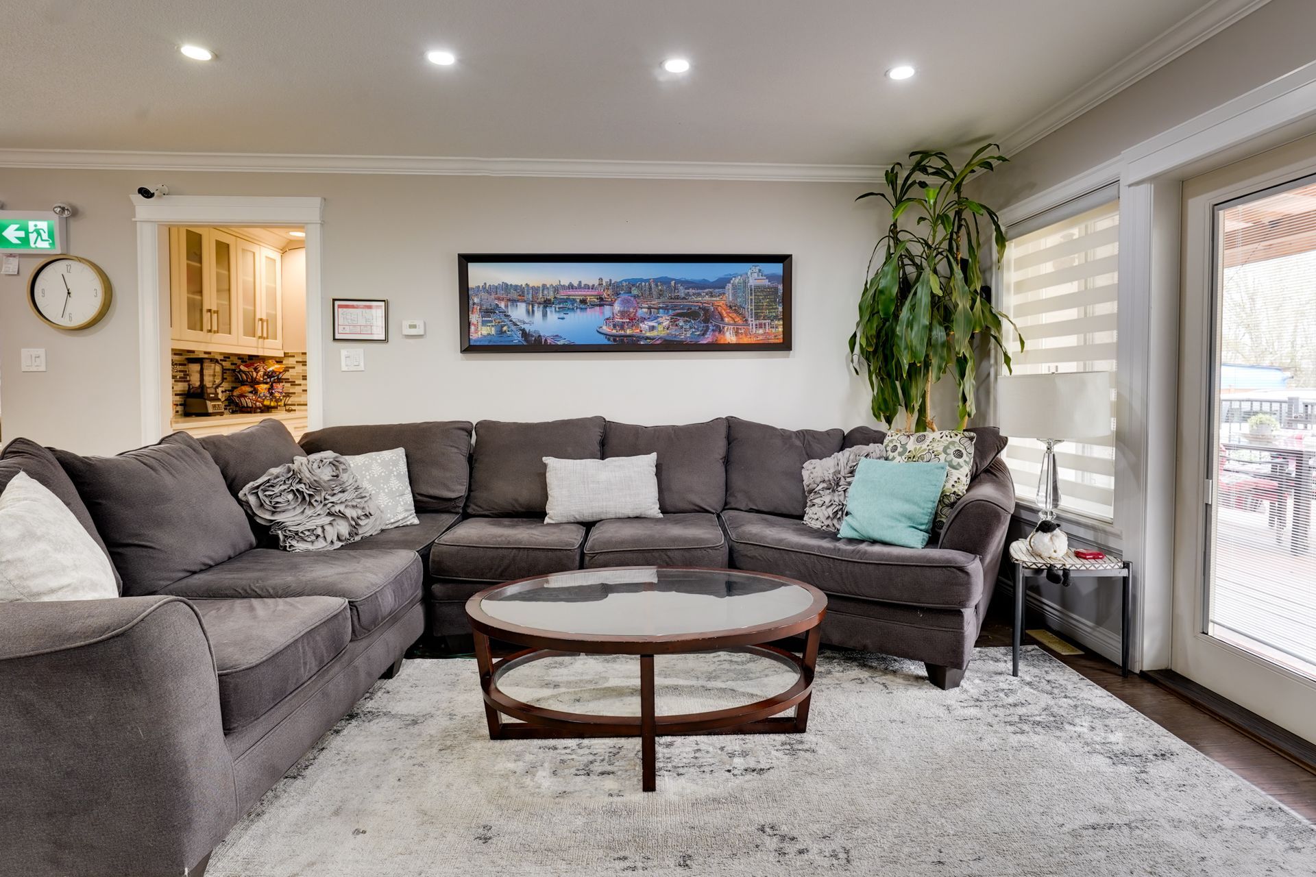 A living room with a large sectional couch and a coffee table.