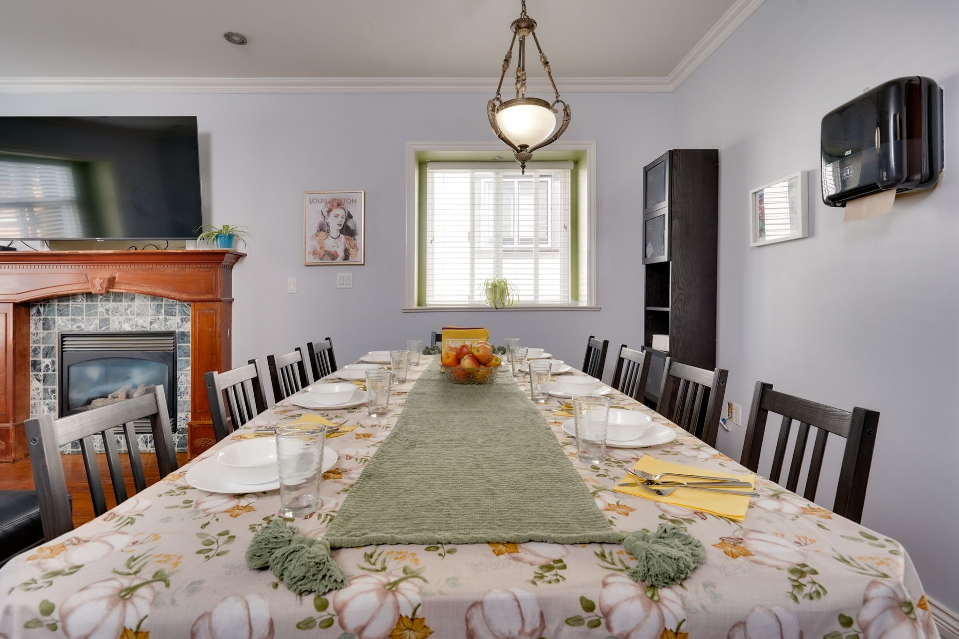A dining room with a long table and chairs