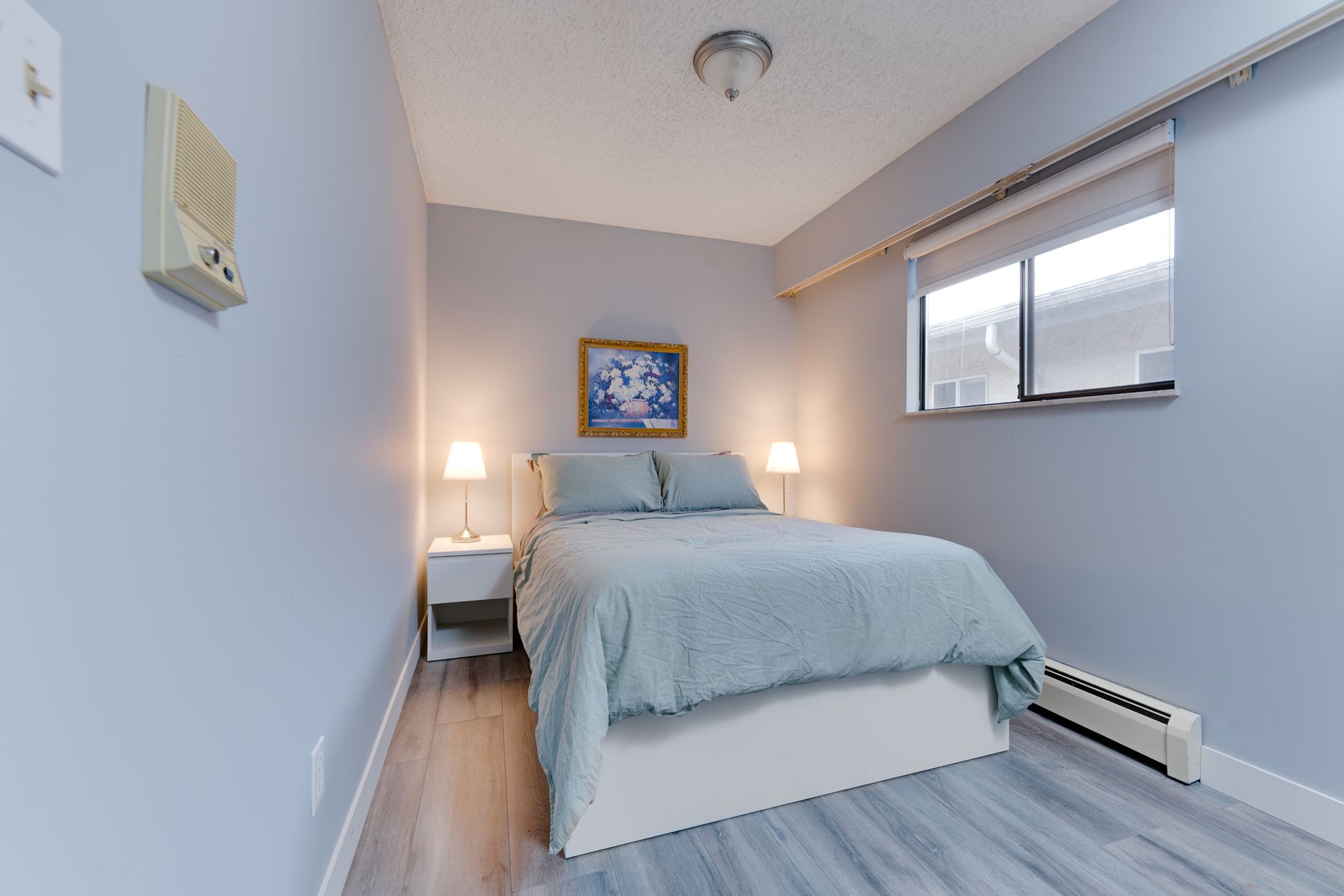 A small bedroom with a bed and a window