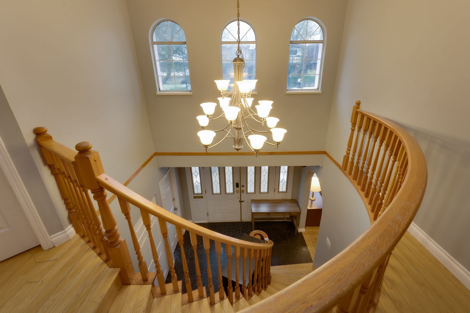 A bedroom with two beds , a desk , and a window.