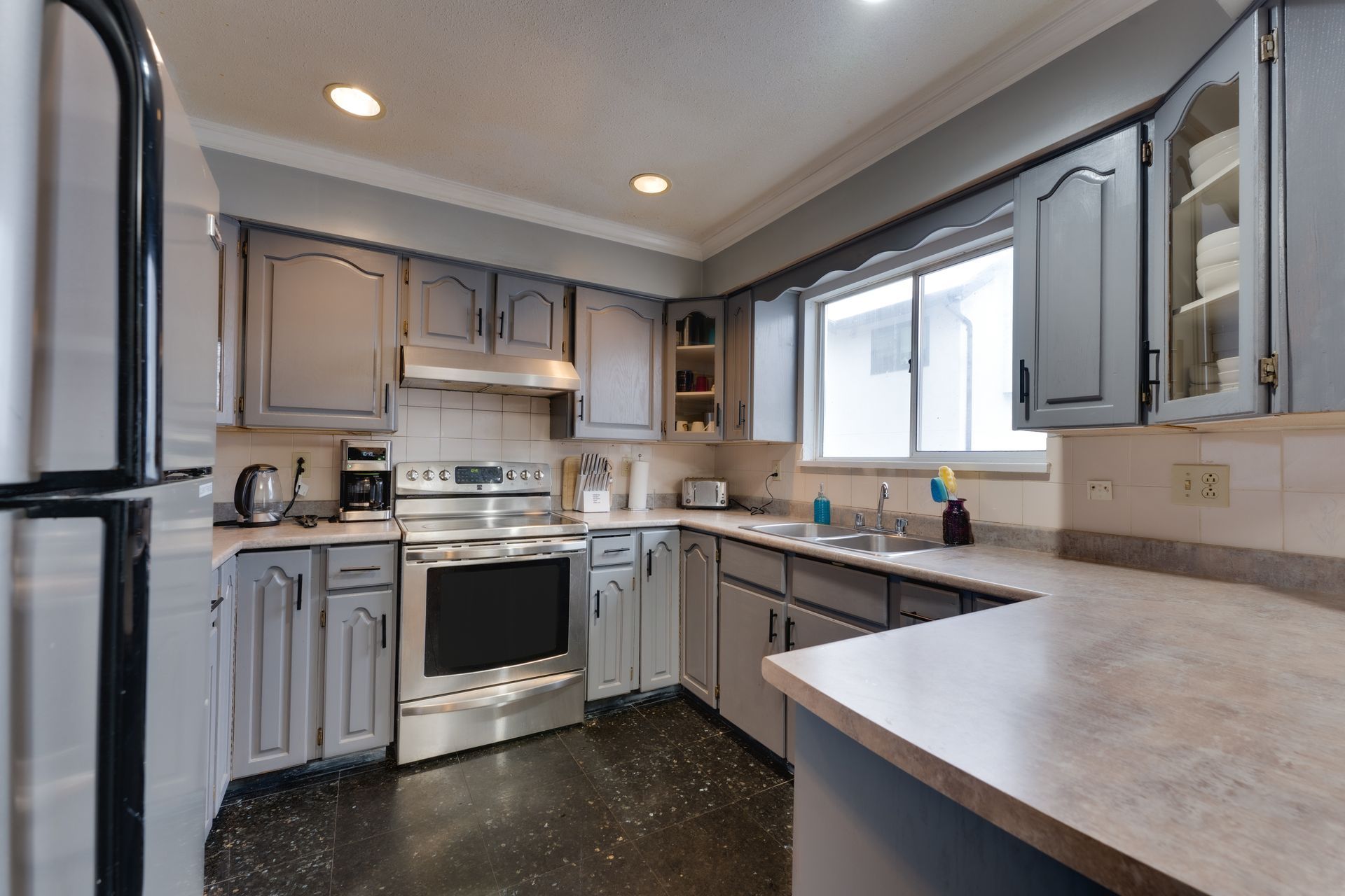 A dining room with a table and chairs and a fireplace.