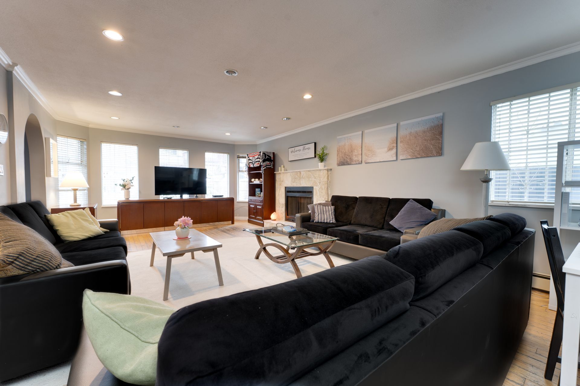 A living room with a wood stove , chairs , bookshelves and a rug.