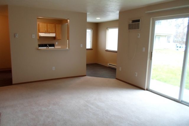 An empty living room with a sliding glass door