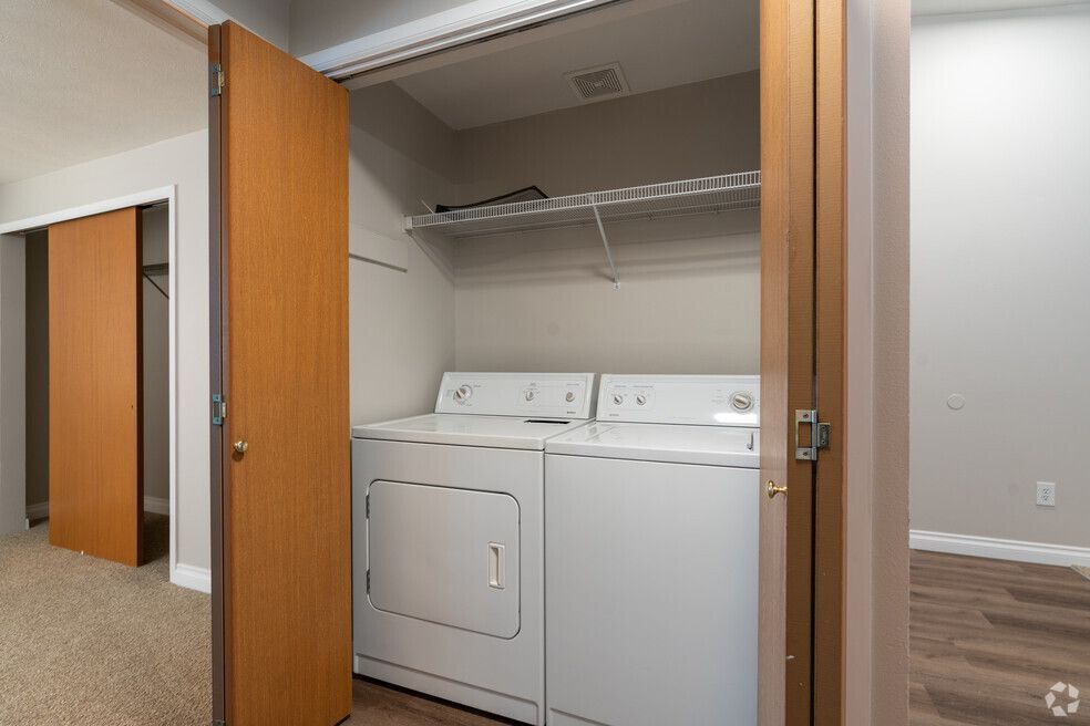 A laundry room with a washer and dryer in a closet.