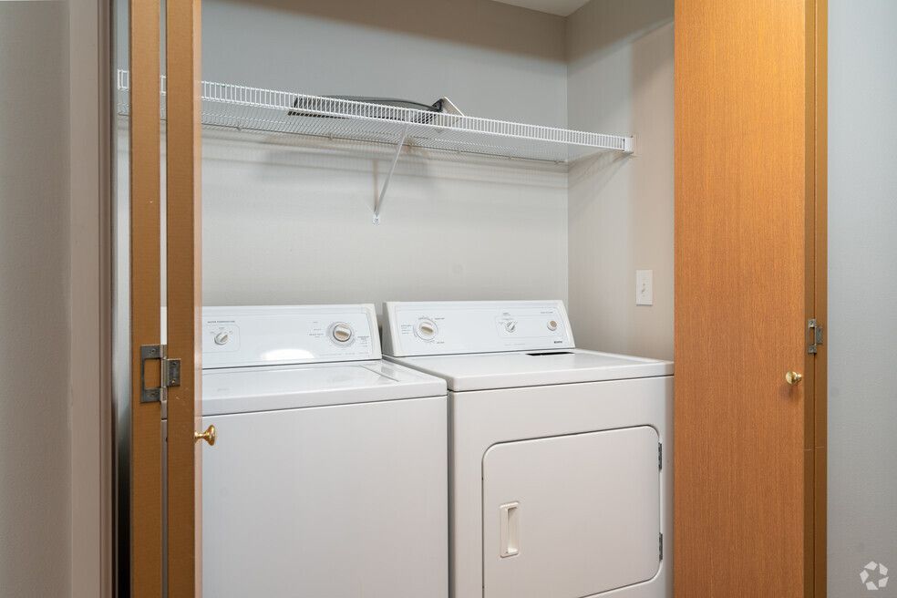 A laundry room with a washer and dryer in a closet.