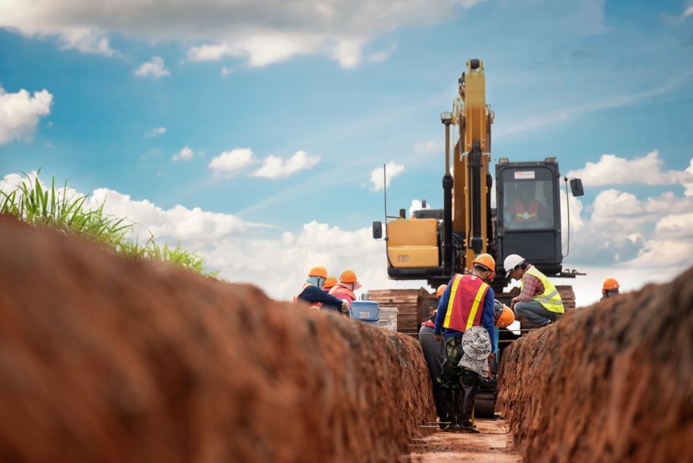 Construction Workers Stand in a Deep Dirt Trench — Environment Restoration Solutions in Waterview Heights, NSW