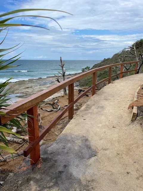 A Wooden Railing Follows a Sandy Coastal Path — Environment Restoration Solutions in Waterview Heights, NSW