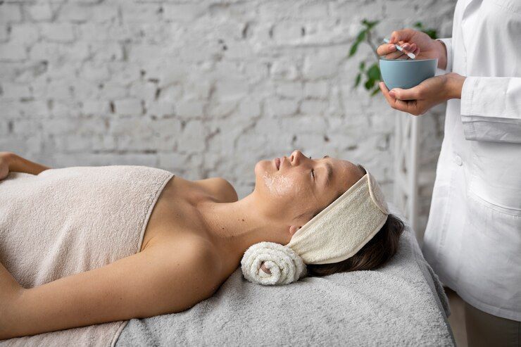 A woman is getting a facial treatment at a spa.