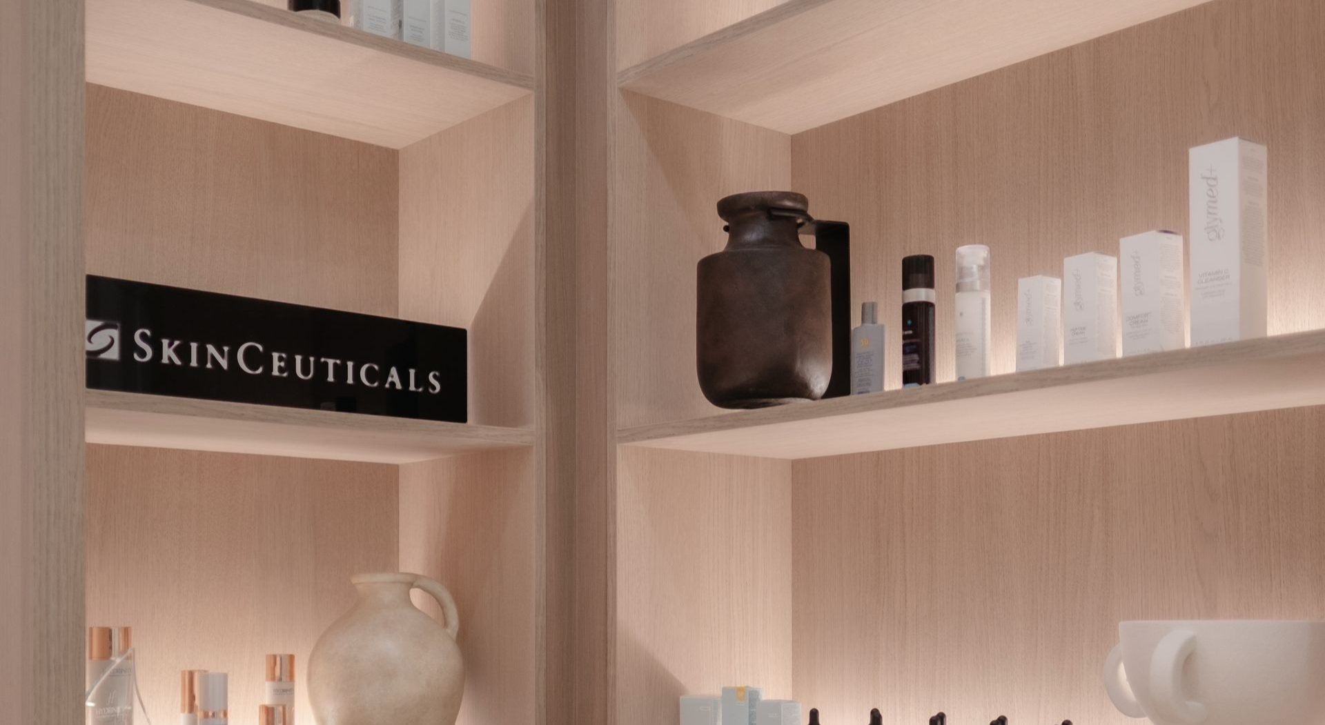 Shelves displaying skincare products, including SkinCeuticals, in a well-lit space.