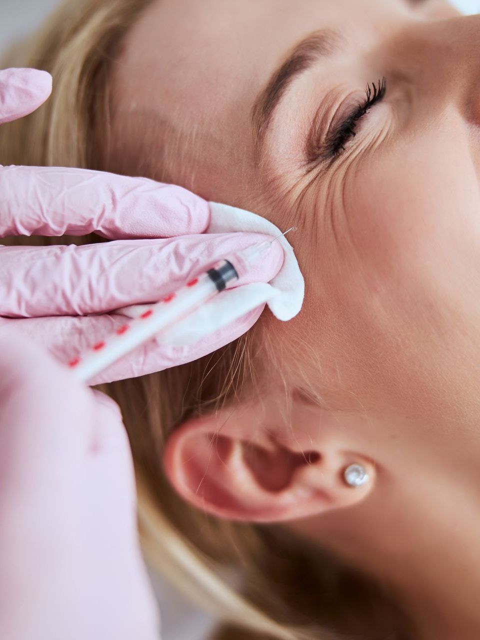 woman getting cosmetic injection in cheek