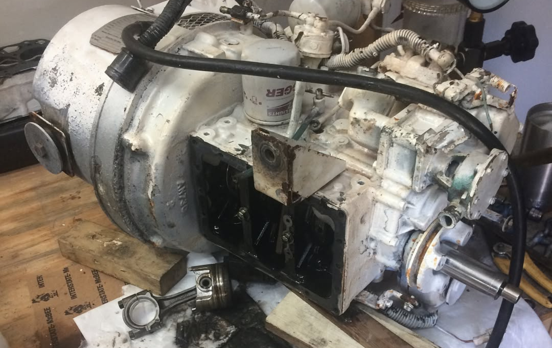 A white engine is sitting on top of a wooden table.