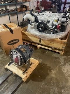 A warehouse filled with lots of boxes and engines.