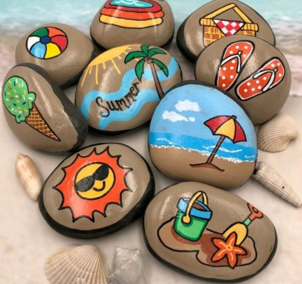 A bunch of rocks with the word summer painted on them
