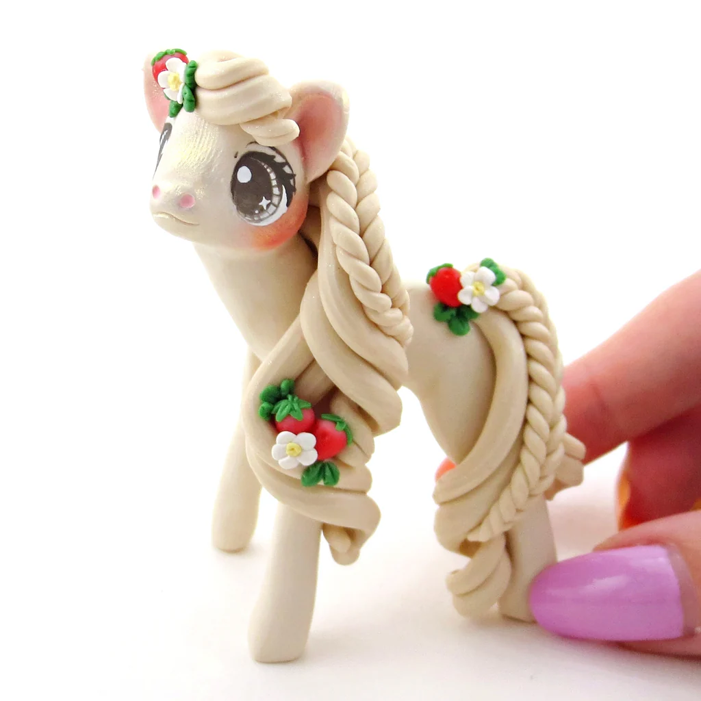 A figurine of a pony with flowers on its mane
