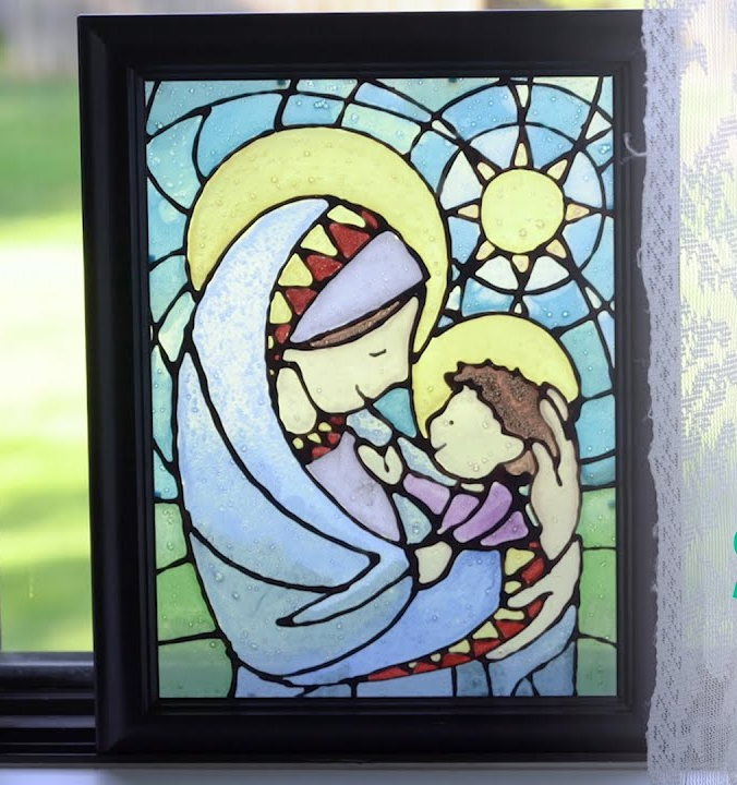 A stained glass painting of a woman holding a baby